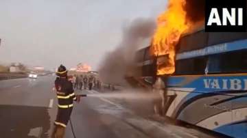 A firefighter tries to control the flames that broke out in a bus.