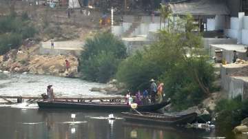 Myanmar residents cross the Moei river on the Thai side.