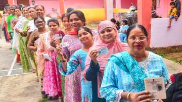 Voters show their identification cards during an election. 