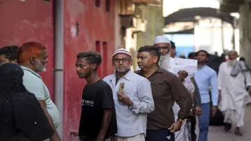 Voters wait to cast their votes for the 2nd phase of Lok Sabha elections.