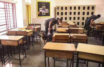 Security personnel inspect a class room at the DPS School after a bomb threat was received by the school via e-mail, at Sector 30, in Noida, Wednesday, May 1, 2024