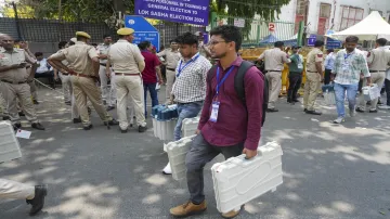 Polling officials leave a distribution center at Gole Market after receiving election material on the eve of the sixth phase of Lok Sabha polls, in New Delhi.