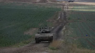 Israeli Defense Forces tank drives away from Gaza  Strip. 