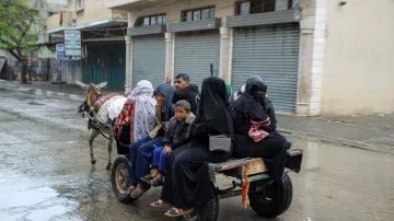 People flee the eastern parts of Rafah after the Israeli military began evacuating Palestinian civil