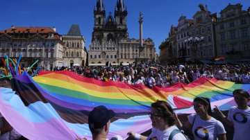 People march during the LGBTQ+ parade at the Old Town Square in Prague, Czech Republic