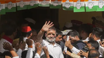 Congress leader and candidate from Rae Bareli constituency Rahul Gandhi waves to supporters after performing ‘havan’ for the Lok Sabha elections, in Rae Bareli.