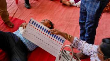 A polling official faints at a distribution center amid heatwave