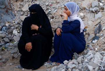 Palestinians hold Eid al-Adha prayers by the ruins of the Al-Rahma mosque destroyed by Israeli air s