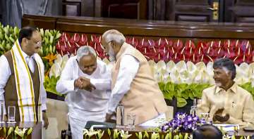 Nitish Kumar touches PM Modi's feet