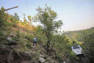 A crane being used to pull out the bus which plunged into a gorge following a terrorist attack on pilgrims, in Reasi district of Jammu and Kashmir