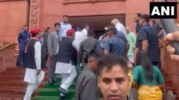 Akhilesh Yadav shakes hands with Amit Shah outside Parliament