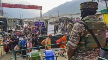 A security personnel stands guard as the first batch of pilgrims for the annual Amarnath Yatra arrives amid tight security, at Baltal, Sonamarg of Ganderbal district of South Kashmir.