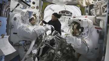 Astronaut Jeanette Epps (Centre) is pictured assisting NASA astronauts Mike Barratt (left) and Tracy