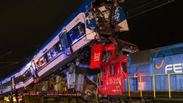 Police and firefighters inspect two trains that collided in San Bernardo, Santiago, Chile.