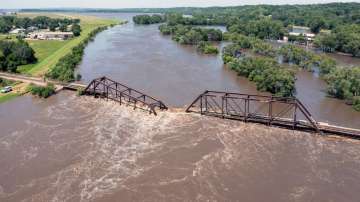Floodwaters pass over a collapsed railroad bridge over the Big Sioux River near North Sioux City