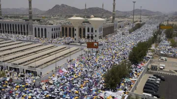 Muslim pilgrims use umbrellas to shade themselves from the sun as they gather outside Nimrah Mosque during the Hajj pilgrimage.