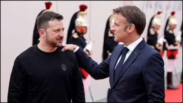 France's President Emmanuel Macron greets Ukraine's President Volodymyr Zelensky at the D-day commemorations.