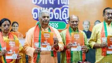 Odisha BJP president Manmohan Samal and other state leaders show manifesto
