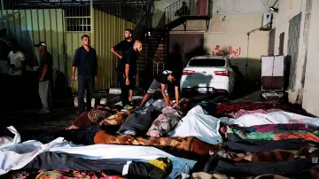 Palestinians check the bodies of their relatives killed in an Israeli bombardment of UNRWA school at