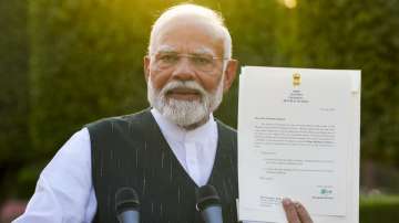 PM Narendra Modi with his letter of his appointment as Prime Minister by President Droupadi Murmu.