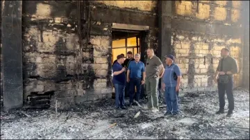 Russian officials visit the Derbent synagogue following an attack by gunmen in Dagestan.