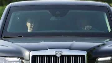 Russia's President Vladimir Putin and North Korea's leader Kim Jong Un ride an Aurus car in Pyongyan