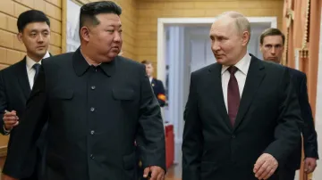 Russian President Vladimir Putin talks with North Korean leader Kim Jong Un during his visit to Pyon