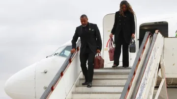 Malawi Vice President Saulos Chilima,left, and his wife Mary disembark from a plane upon his return 