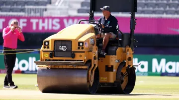 Groundstaff work on the pitch at the Nassau County International Cricket Stadium.