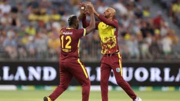 Roston Chase celebrates with Andre Russell.