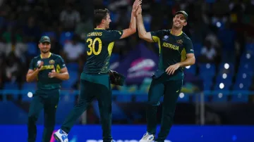 Pat Cummins celebrates with Mitchell Marsh.