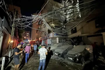 People inspect damaged cars in the southern suburbs of Beirut, Lebanon, Tuesday, July 30, 2024