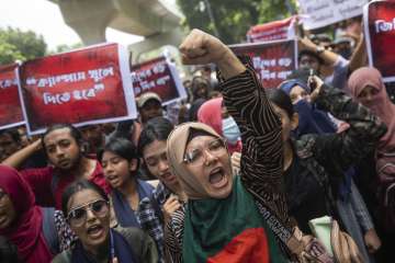 University students shout slogans during a protest to demand justice for the victims killed in the recent countrywide deadly clashes and ask for their campuses to be opened, in Dhaka