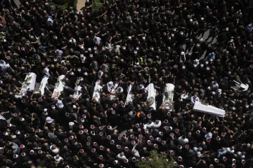 Bodies of those killed in the football stadium attack were brought to a community centre in Majdal S