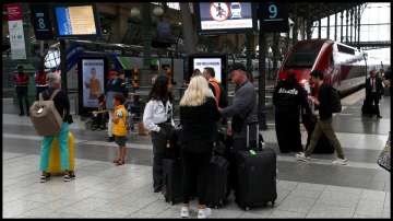 Passengers are pictured at Gare du Nord station after threats against France's high-speed TGV network.