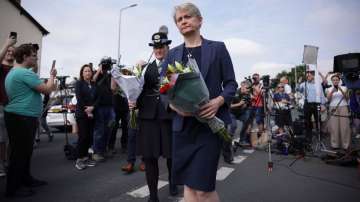 UK Home Secretary Yvette Cooper brings flowers to the scene in Hart Street where two children died a