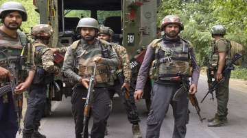 Security personnel stand guard during an encounter with terrorists, in Kulgam.