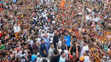 Hardik Pandya and Krunal Pandya on an open bus with thousands of fans around.