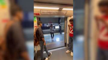 Youth performs dance on 'naacho naacho' inside Delhi Metro coach.