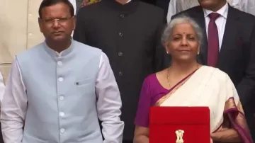 Nirmala Sitharaman poses with tablet in red sleeve