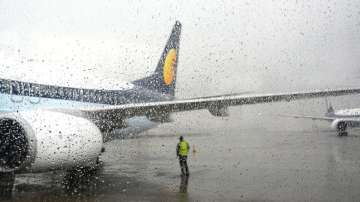 A plane stationed at the airport during rains in Mumbai