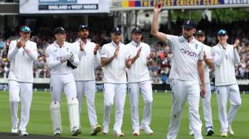 Gus Atkinson leads England players off the field.