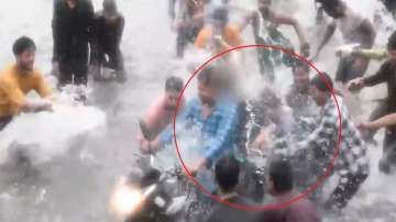 Snapshot from the horrific video in which several people were seen mistreating the woman