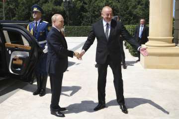 Azerbaijani President Ilham Aliyev, right, greets Russian President Vladimir Putin at Zagulba state 