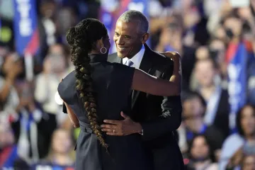 Former President Barack Obama hugs his wife during the Democratic National Convention Tuesday