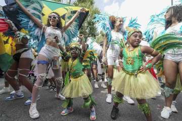 Children dance along the parade route