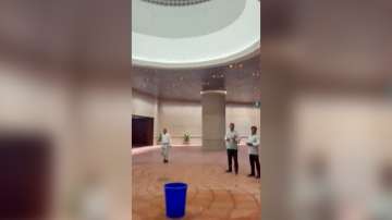 This screenshot shows rain water leaking from a ceiling of the New Parliament building, in New Delhi