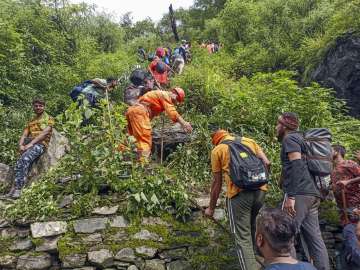 NDRF personnel evacuating stranded pilgrims on the route between Sonprayag and Bhimbali, following cloudburst in Kedarnath. 