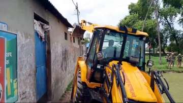 A bulldozer being used to demolish the bakery of Moid Khan who is accused of allegedly raping a 12-year-old girl in Ayodhya