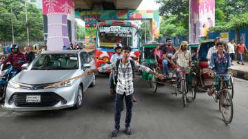 A student directs traffic in Dhaka, Bangladesh